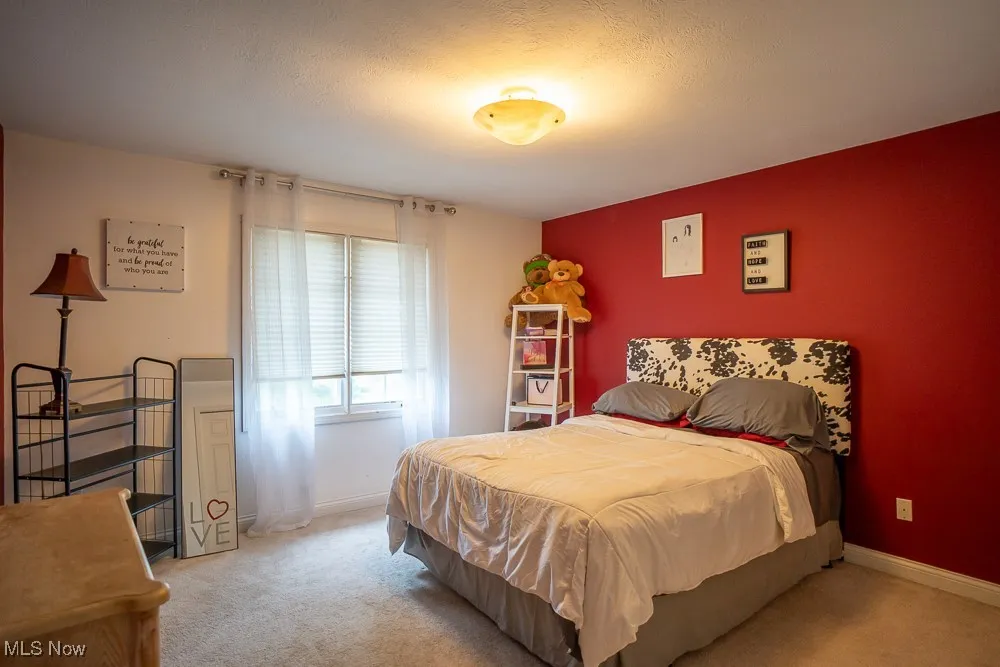 Bedroom with carpet and a textured ceiling