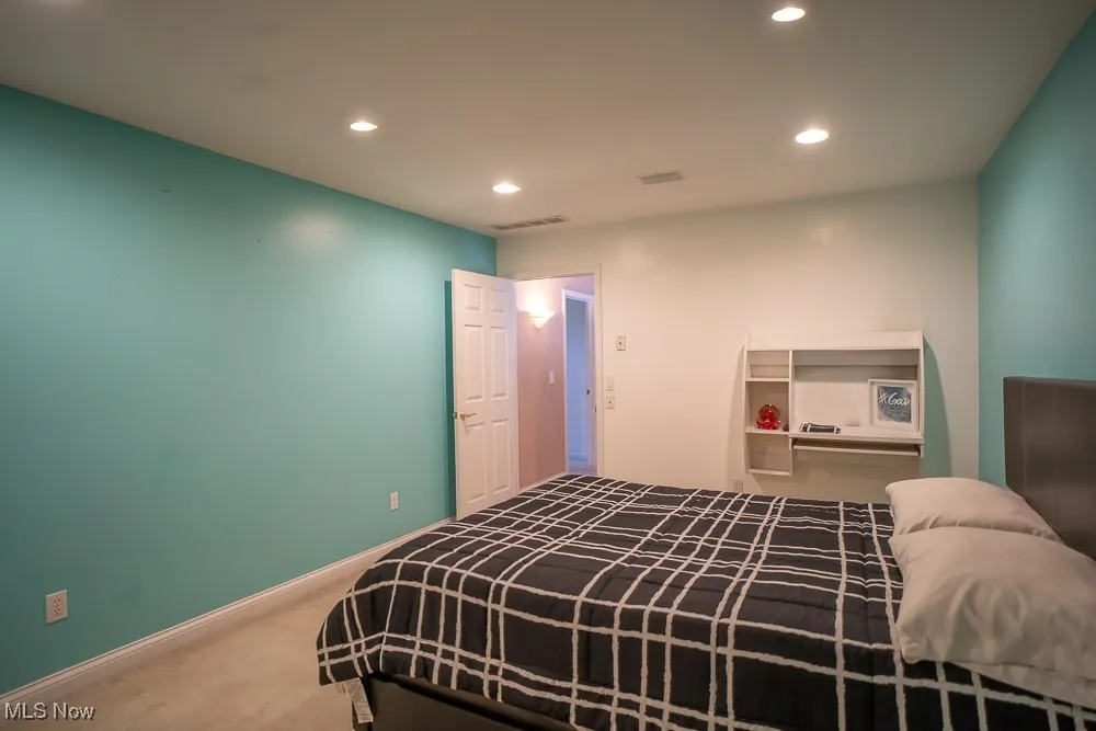 Carpeted bedroom featuring recessed lighting and baseboards