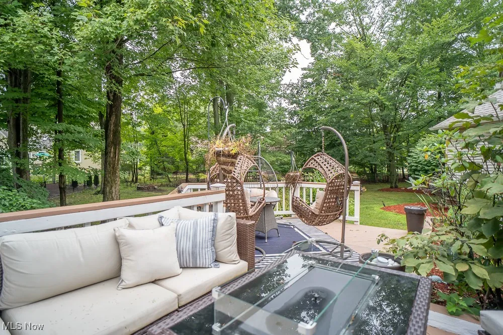 View of patio / terrace with view of scattered trees, outdoor lounge area, and a wooden deck