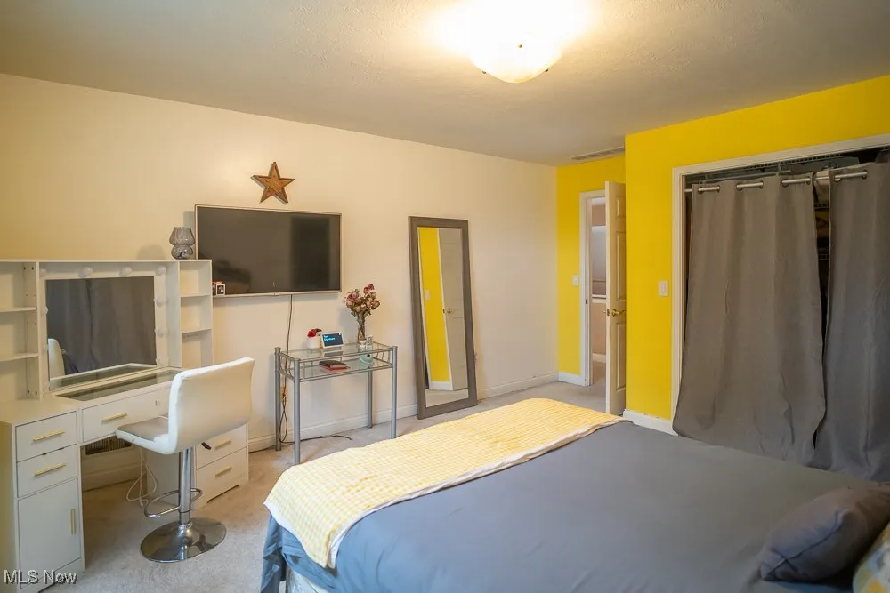 Bedroom featuring carpet floors and a closet