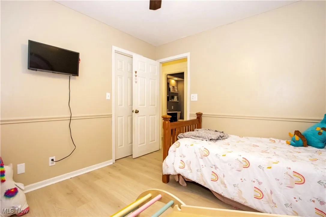 Bedroom with light wood-style flooring and ceiling fan