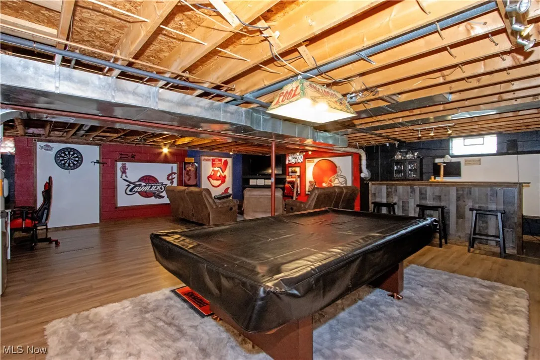 Playroom with billiards table and wood finished floors