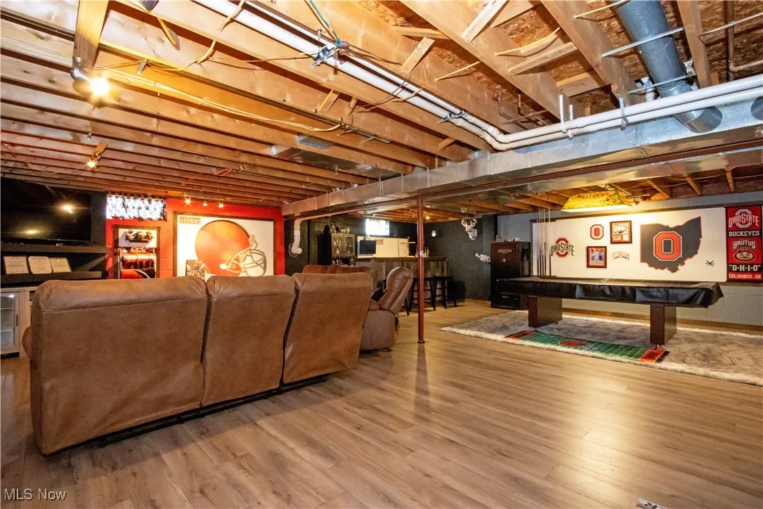 Below grade area with wood finished floors and billiards table