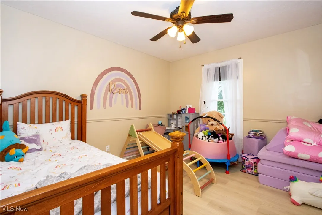 Bedroom featuring wood finished floors and ceiling fan