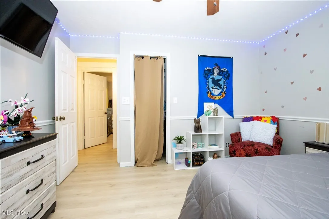 Bedroom with light wood finished floors and a ceiling fan