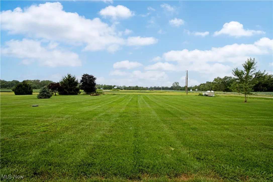 View of home's community featuring a lawn and a view of countryside