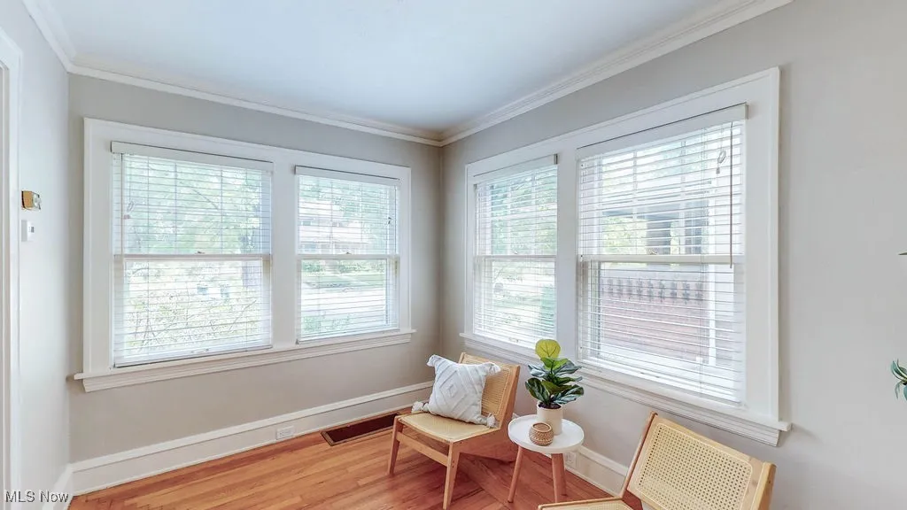 Den with lots of natural light and hardwood floors.