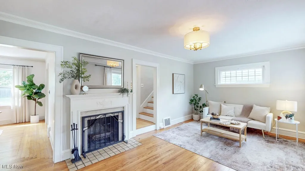 Living room with fireplace and hardwood floors.