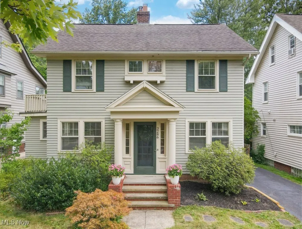 Front exterior of Colonial home with landscaping and japanese maple.