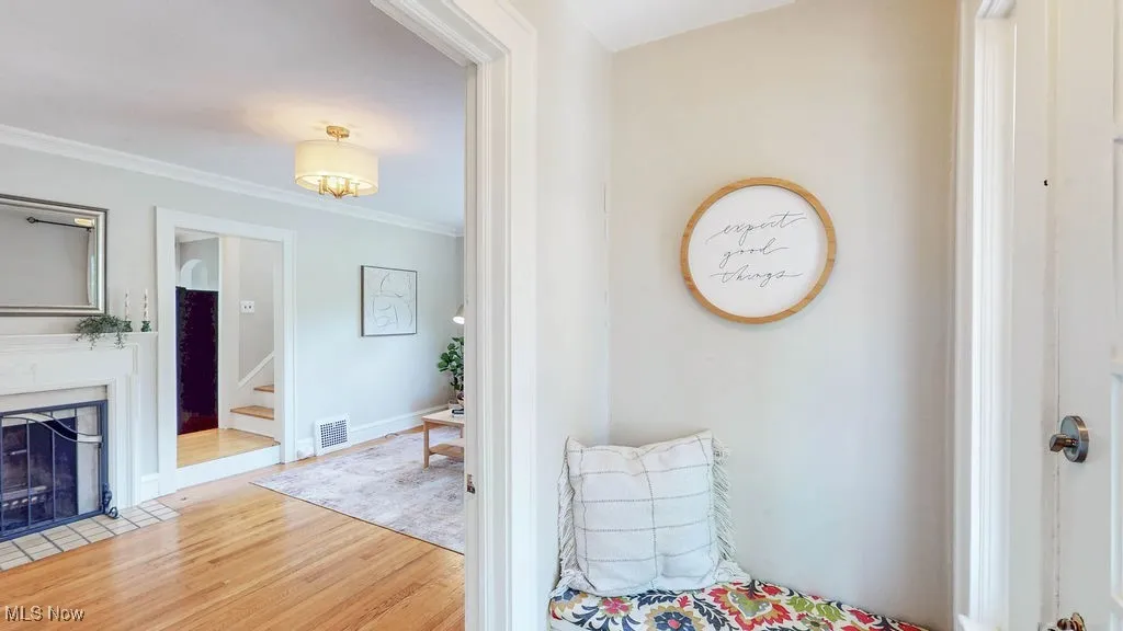 Entryway with built-in bench that opens to living​​‌​​​​‌​​‌‌​‌‌​​​‌‌​‌​‌​‌​​​‌​​ room.