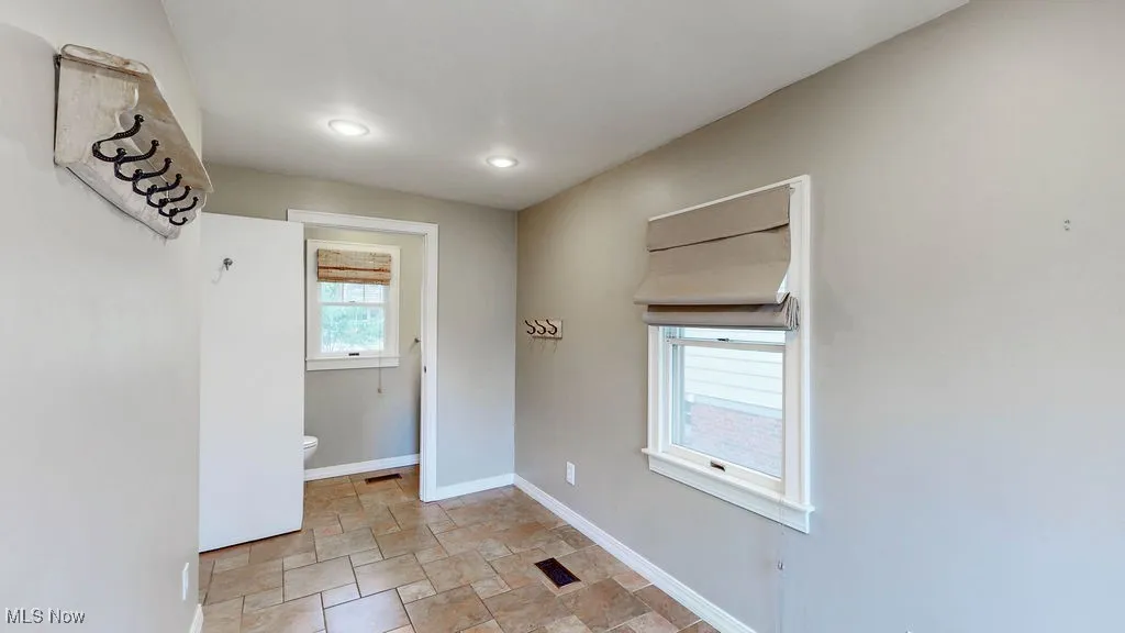 Additional view of mud room with attached half bath.
