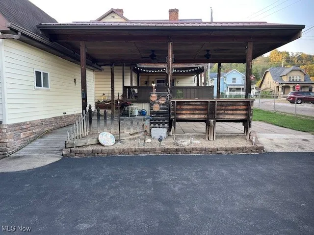 View of patio / terrace with a fenced front yard and ceiling fan