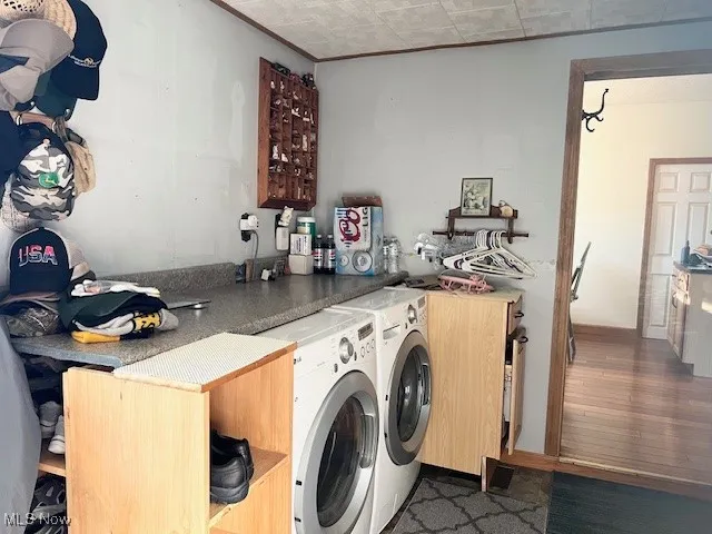 Laundry area featuring dark wood-style flooring and separate washer and dryer