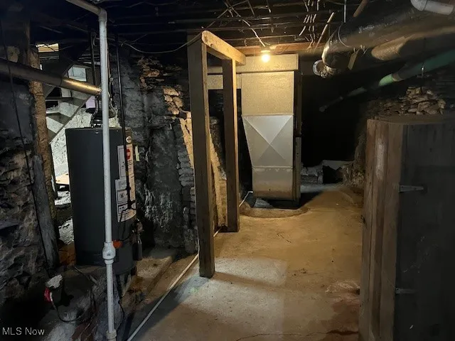 Unfinished basement with water heater and heating unit