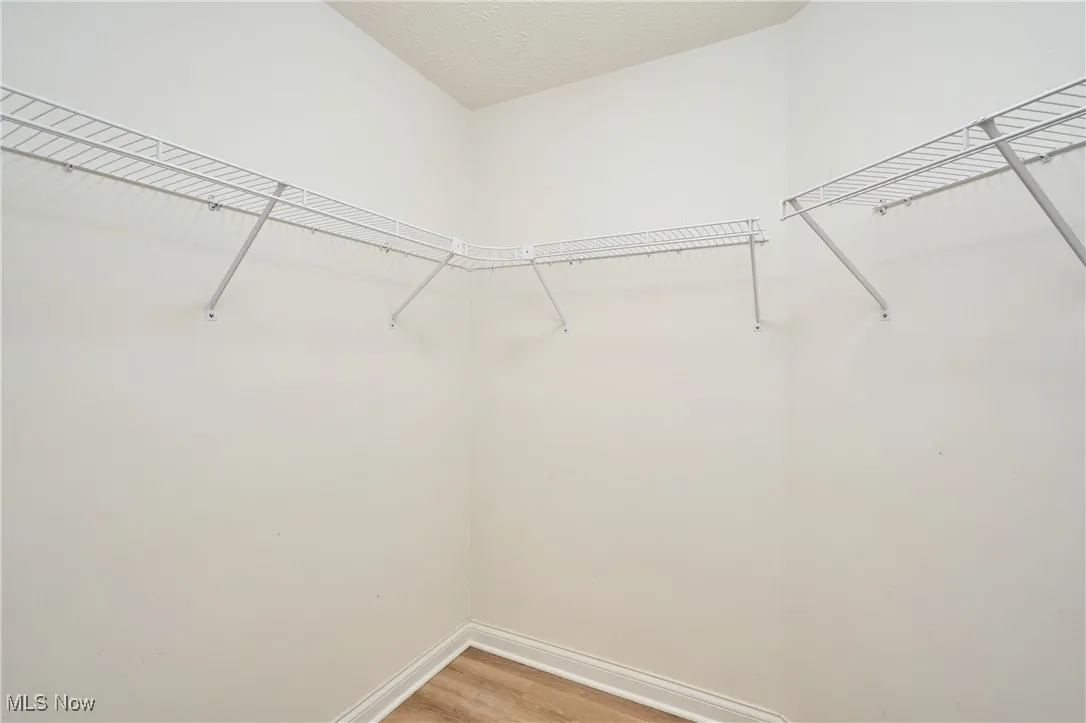 walk-in closet located in the primary bathroom