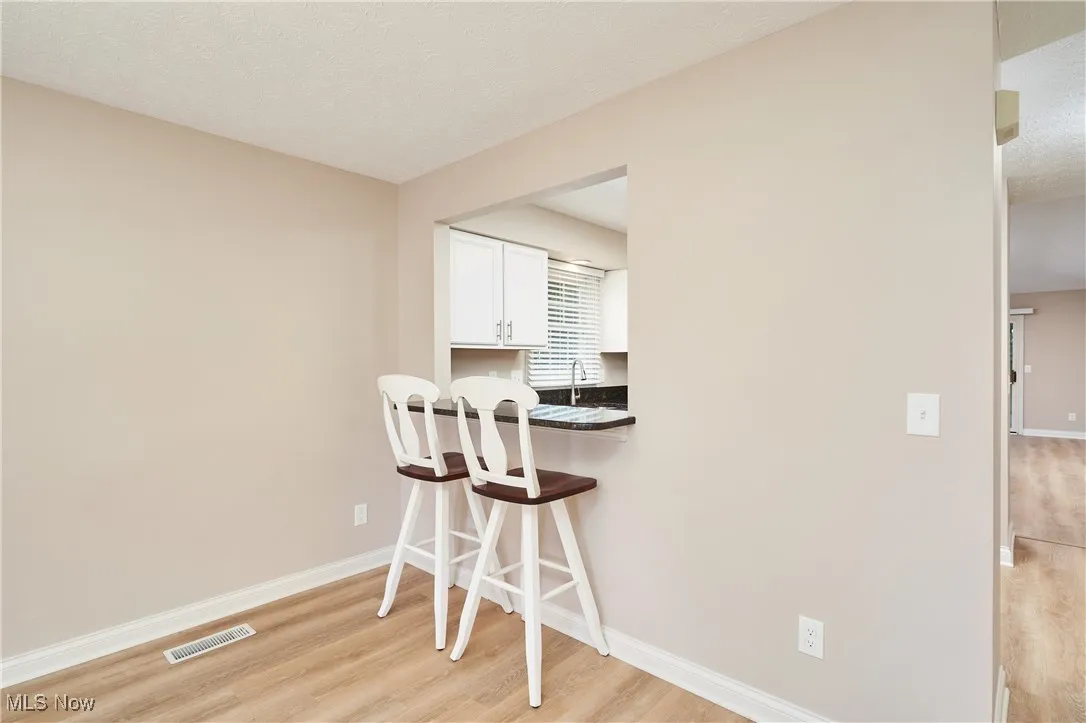 two bar stools fit at counter between dining area and kitchen