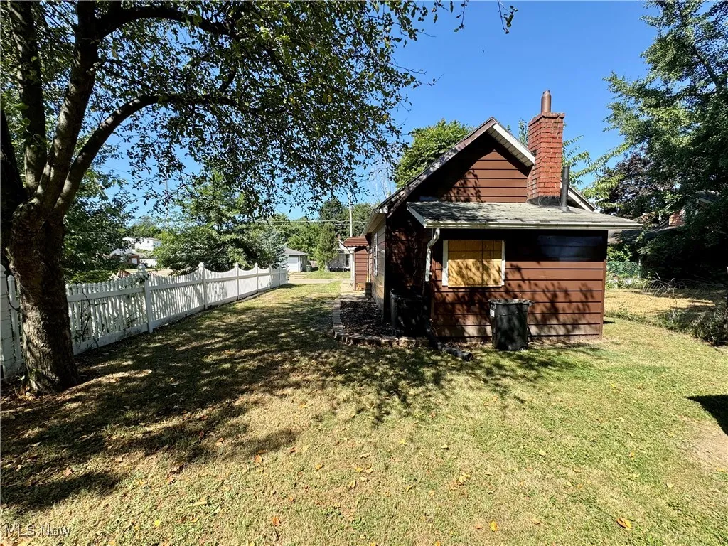Back of house featuring a chimney