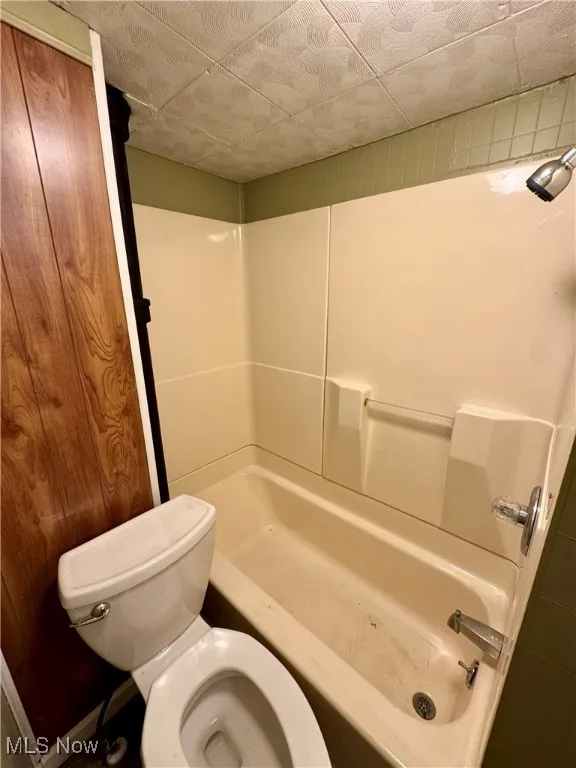 Bathroom with toilet and bathtub / shower combination