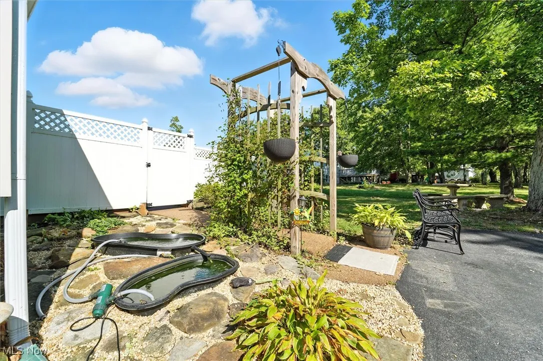 Archway leading to the pool - 2 pond water feature to the left