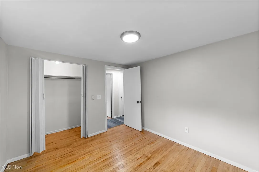 Unfurnished bedroom featuring light wood finished floors and a closet