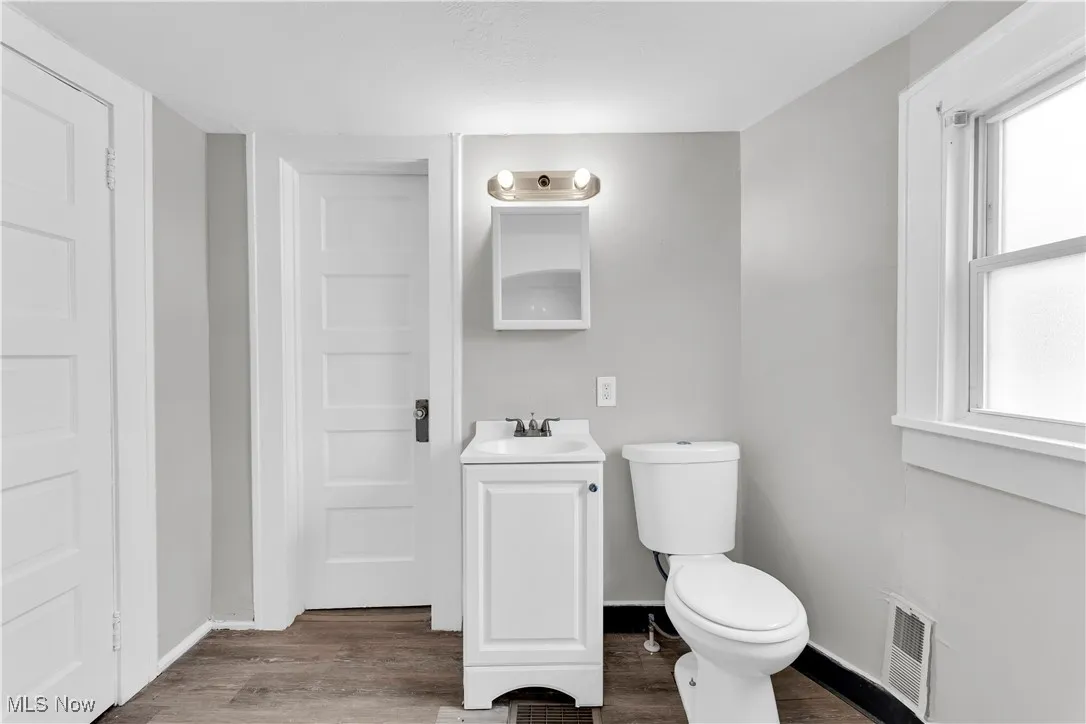 Bathroom with vanity and wood finished floors