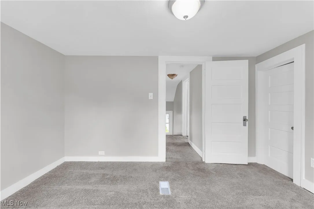 Spare room with carpet floors and baseboards