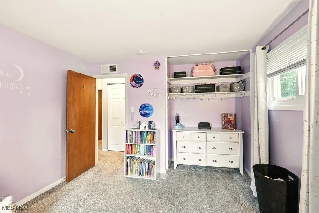 Bedroom featuring light colored carpet and baseboards