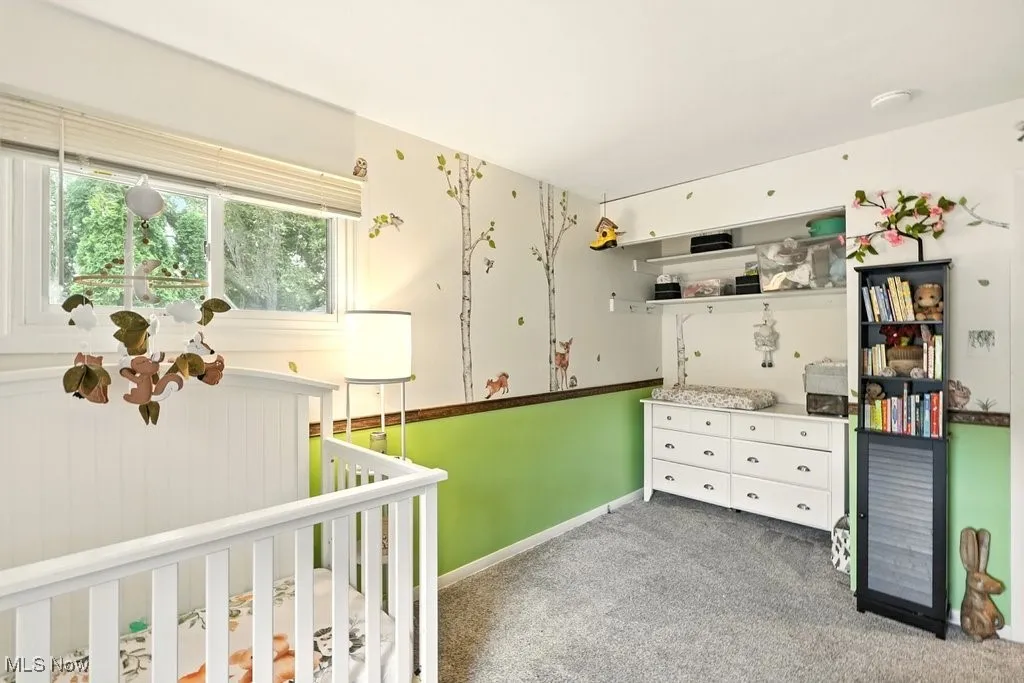 Bedroom with carpet flooring and a nursery area