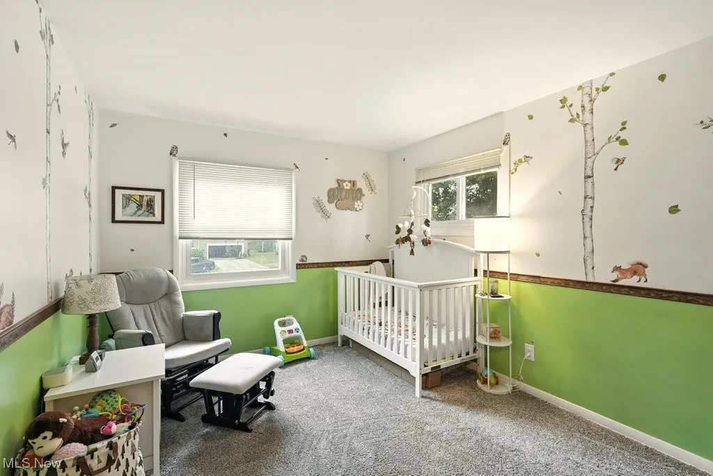 Bedroom with carpet flooring and a nursery area