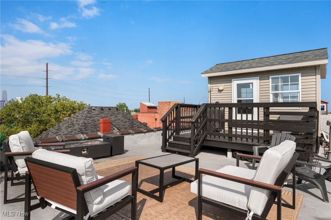 View of patio featuring an outdoor living space and a wooden deck