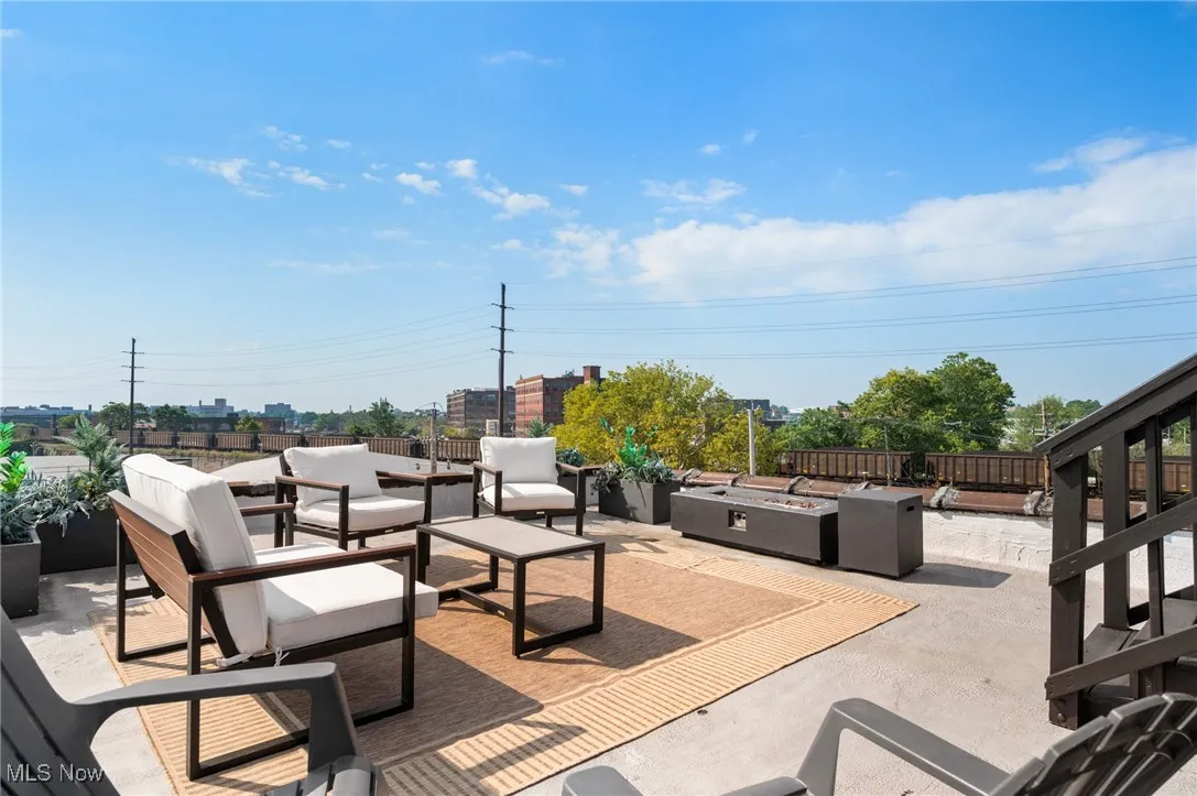 View of patio featuring an outdoor living space with a fire pit