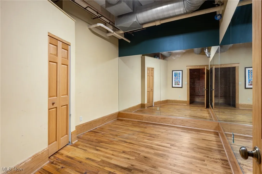 Empty room with wood-type flooring and baseboards