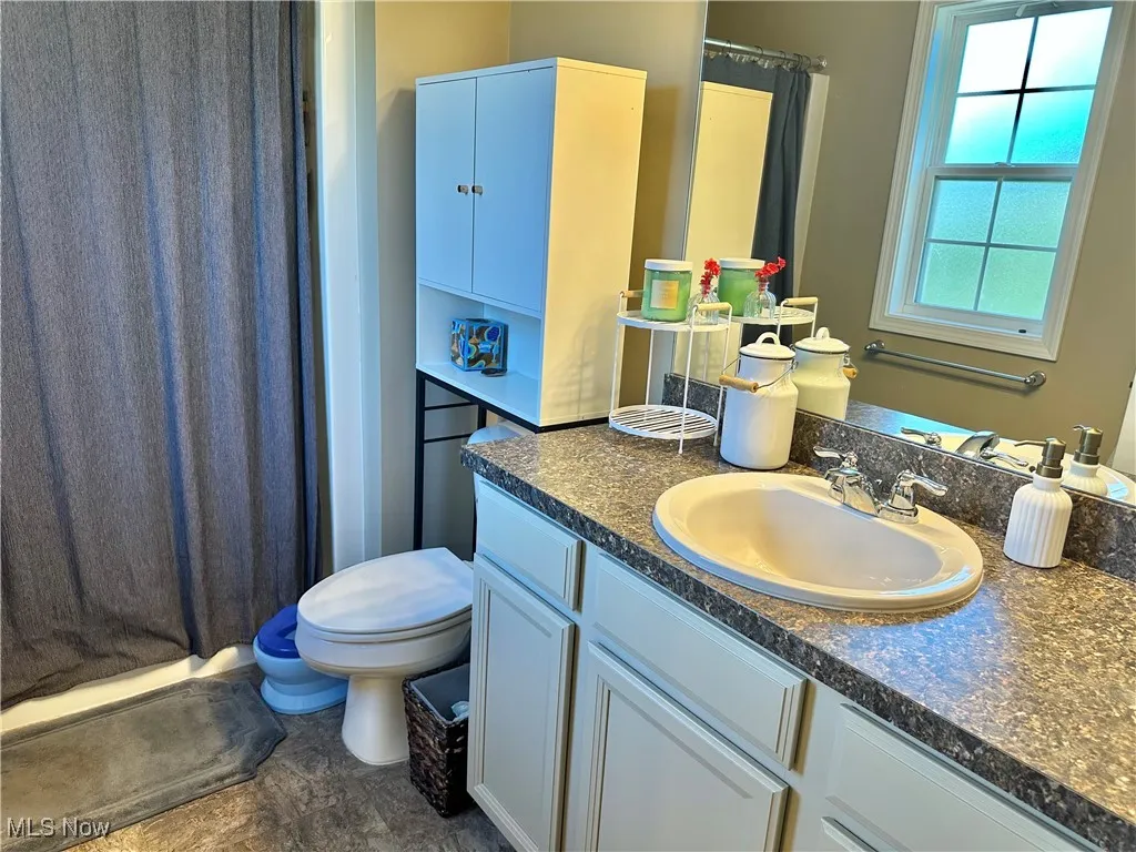 Full bath featuring vanity and a stall shower