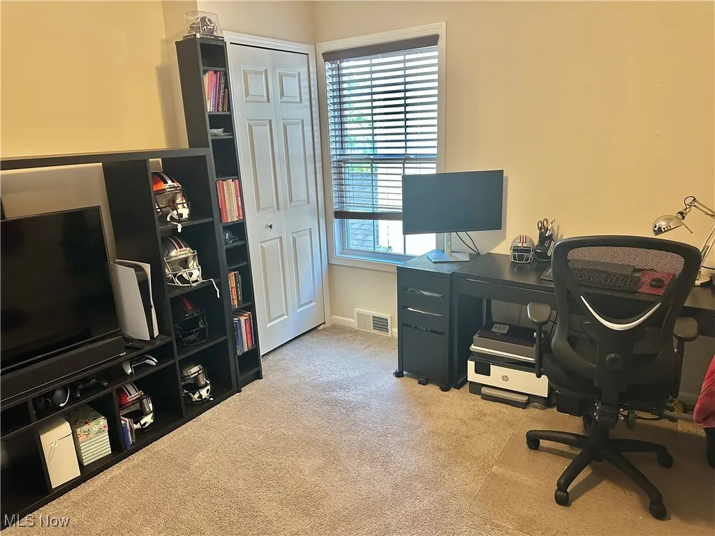 Office space with plenty of natural light and light carpet