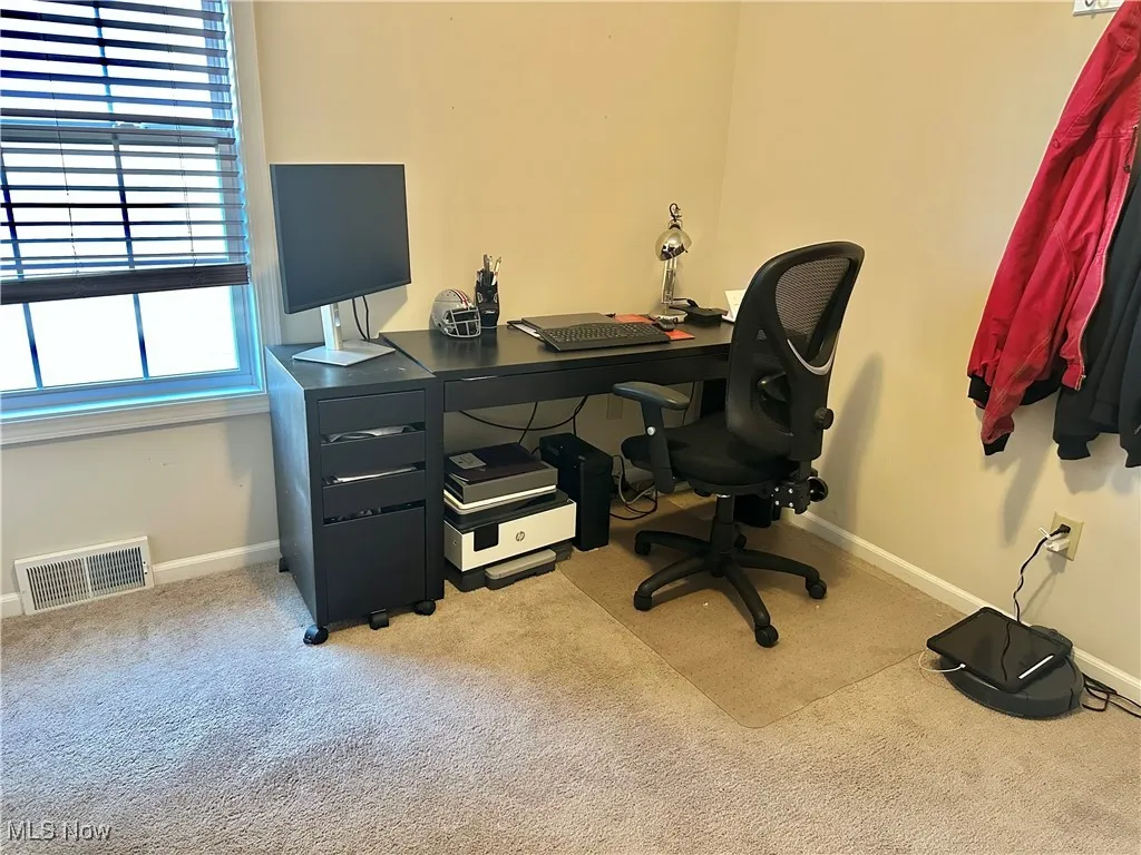 Home office with light carpet