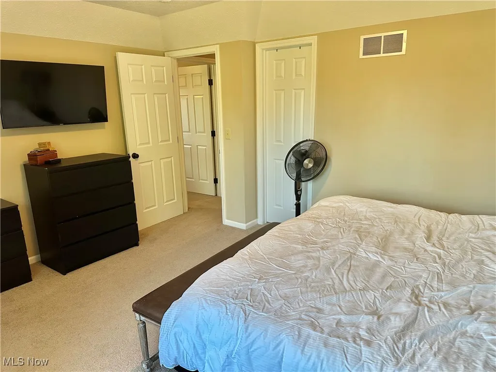 Bedroom with carpet flooring and baseboards