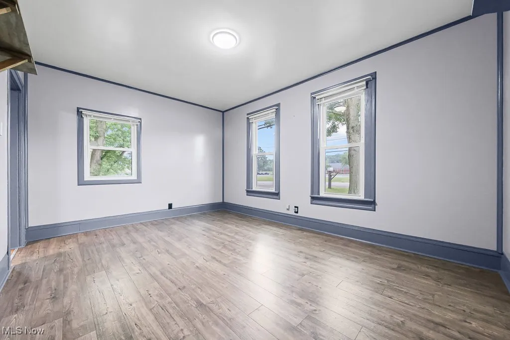 Living room with hardwood / wood-style flooring and baseboards