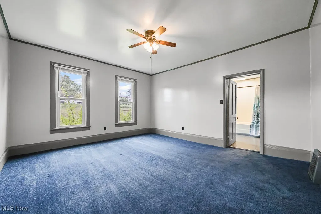 Bedroom featuring ornamental molding, carpet flooring, and ceiling fan