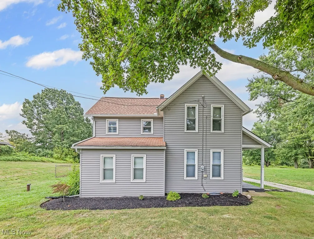 Front of property featuring a yard and roof with shingles