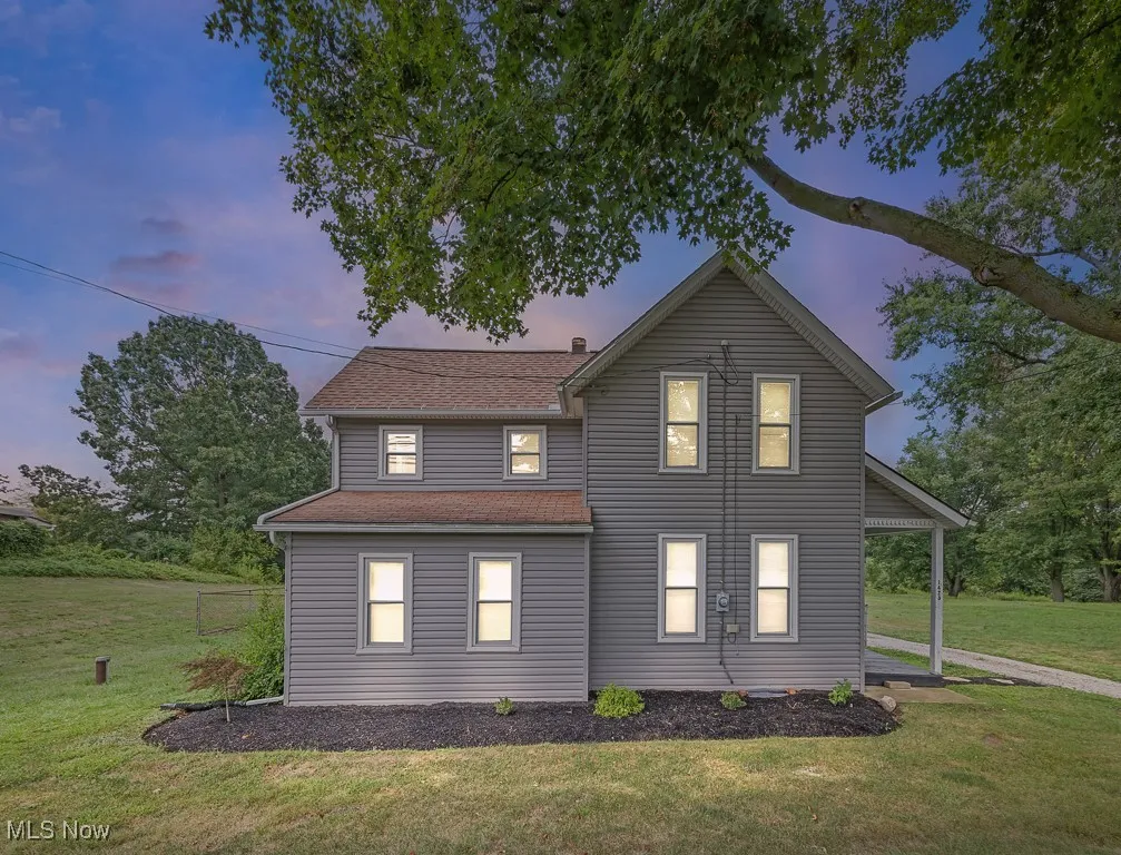 Front of house featuring a lawn and roof with shingles