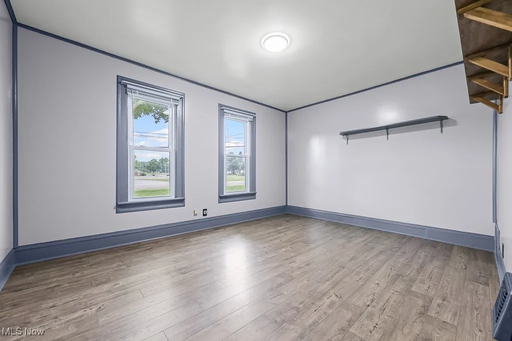Unfurnished living room with light wood-style flooring