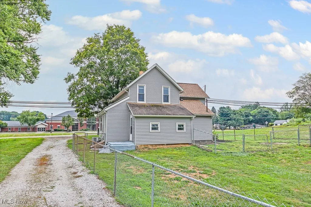 View of side of home with driveway