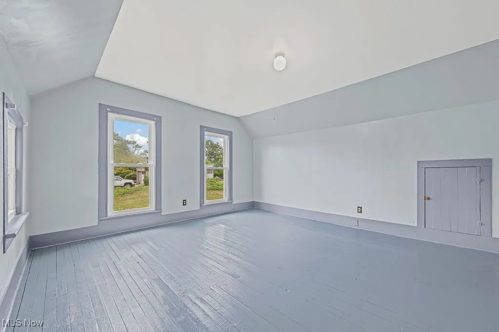 Bedroom featuring lofted ceiling and wood-type flooring