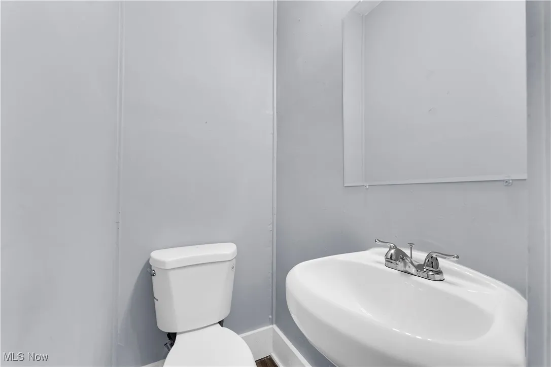 Half bathroom featuring a sink and toilet