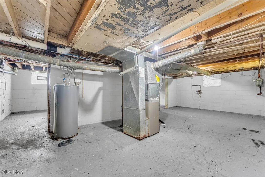 Below grade area with heating unit and gas water heater