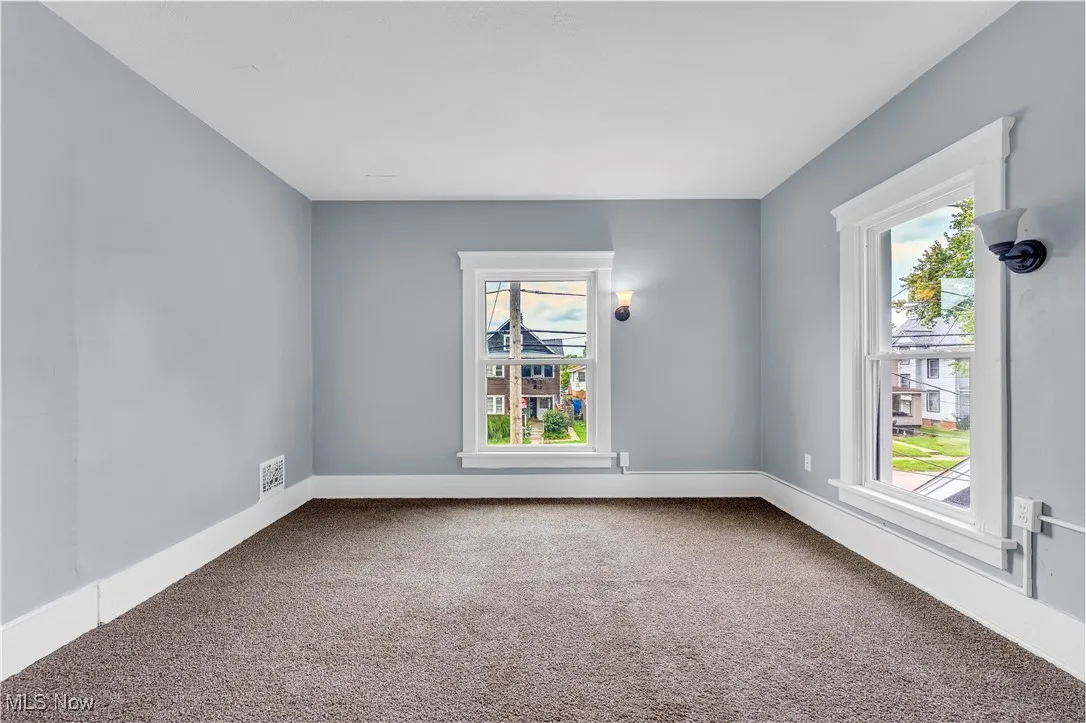 Unfurnished room featuring carpet flooring and baseboards
