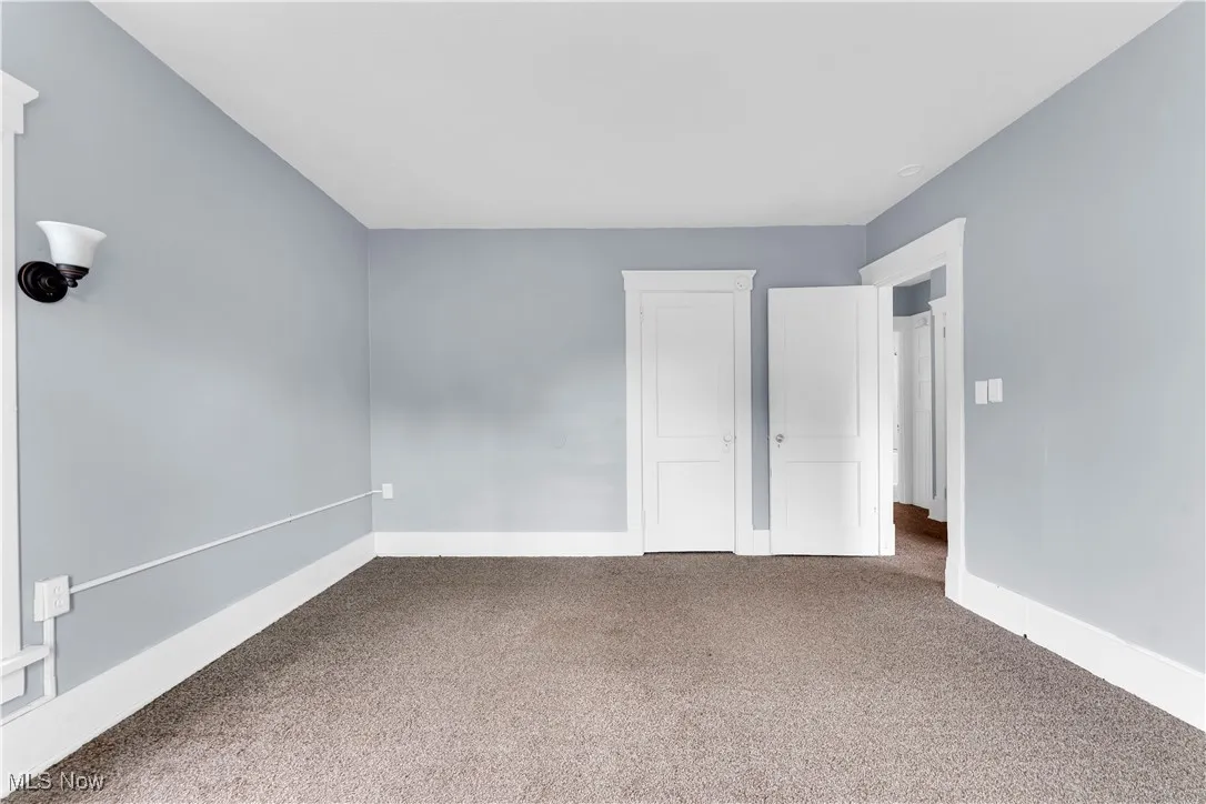 Unfurnished bedroom featuring carpet flooring and a closet