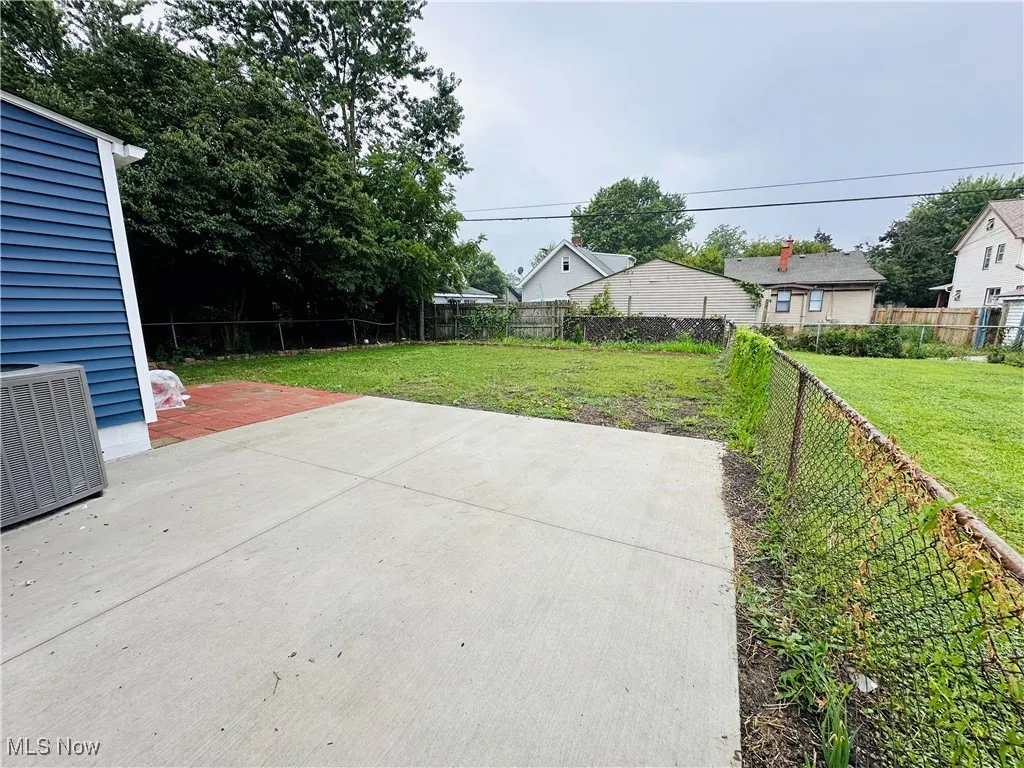 Fenced backyard with a patio
