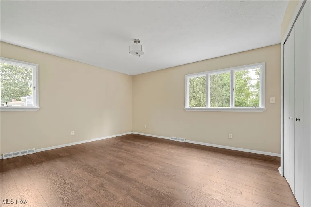 Primary bedroom with engineered wood flooring