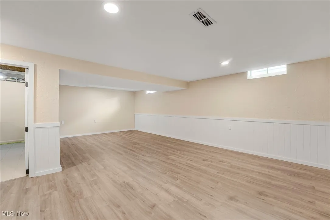 Finished rec room featuring luxury vinyl flooring